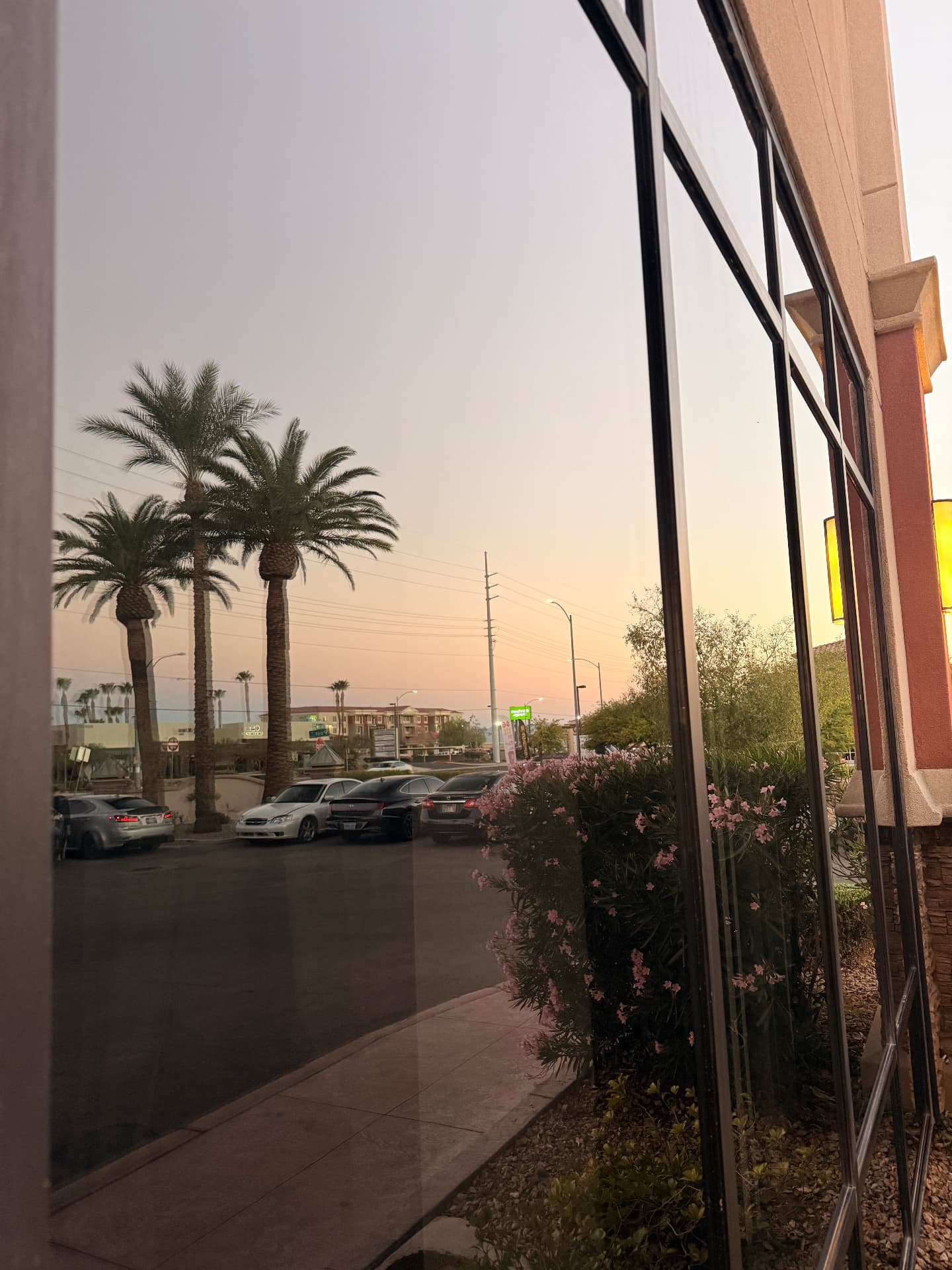 Mirror-like storefront glass at sunset