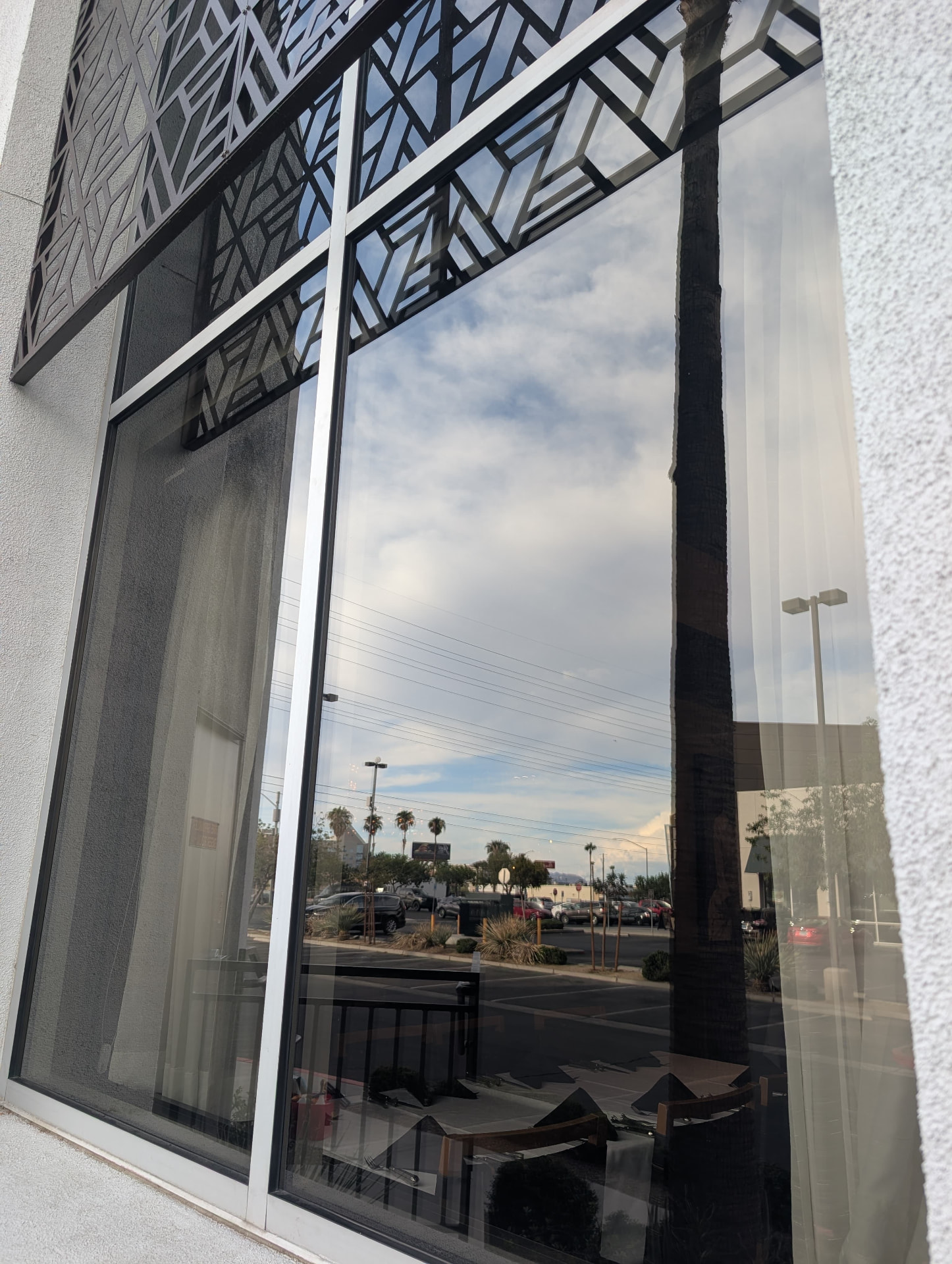 Streak-free exterior restaurant window reflecting the sky